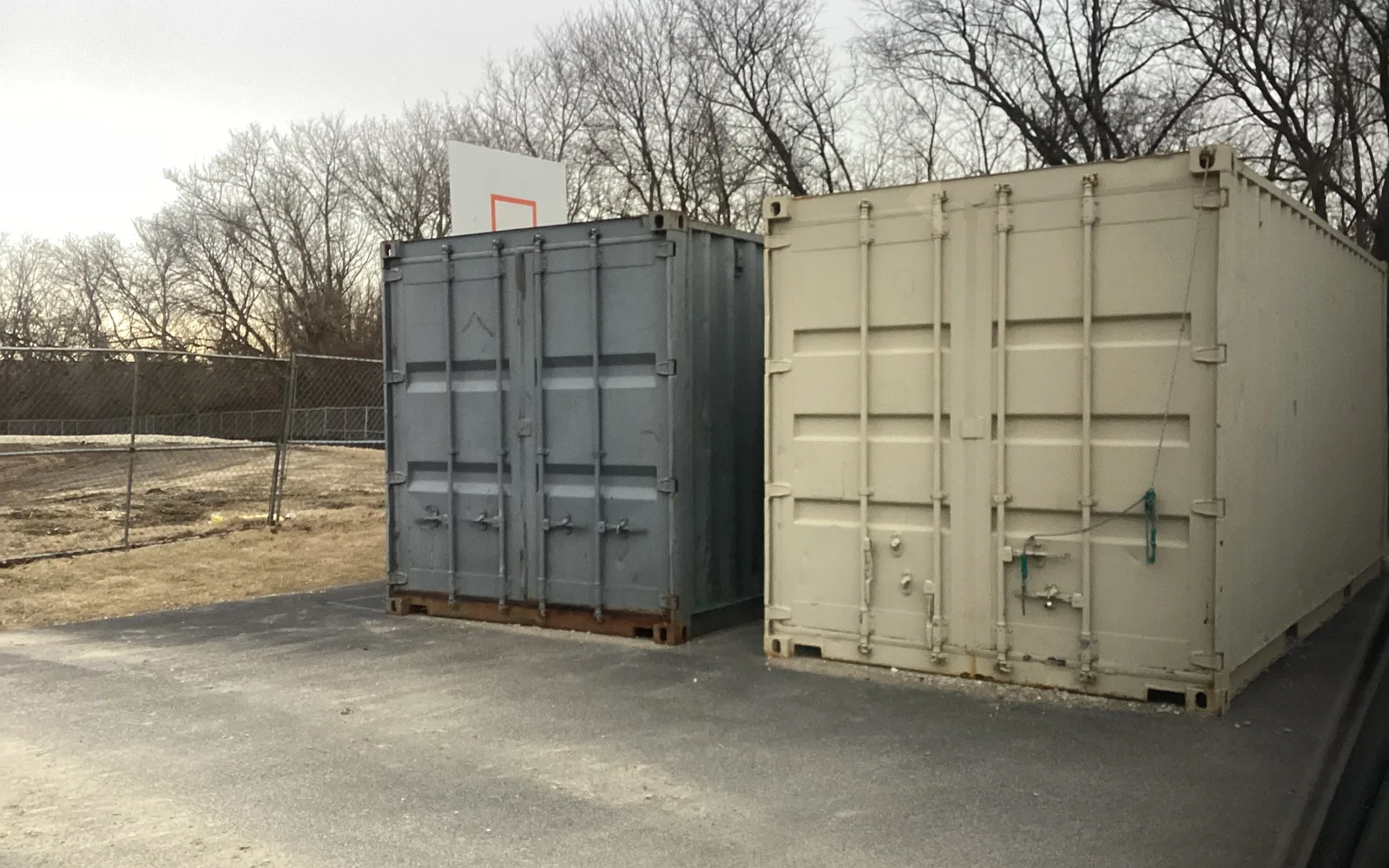 Stacked shipping containers in blue and gray colors